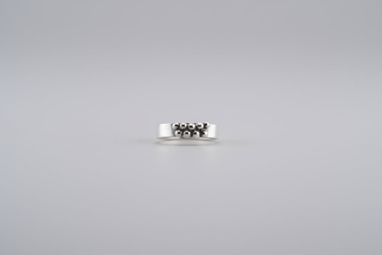 Petite Lady - Rounded sterling wire with soldered casting beads on a white background